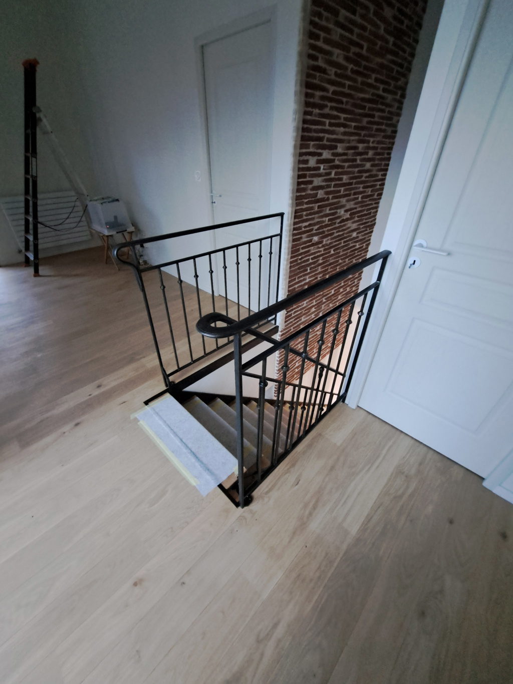 Escalier design en acier patiné et chêne massif intégré à l’intérieur du projet La Motte-Tilly