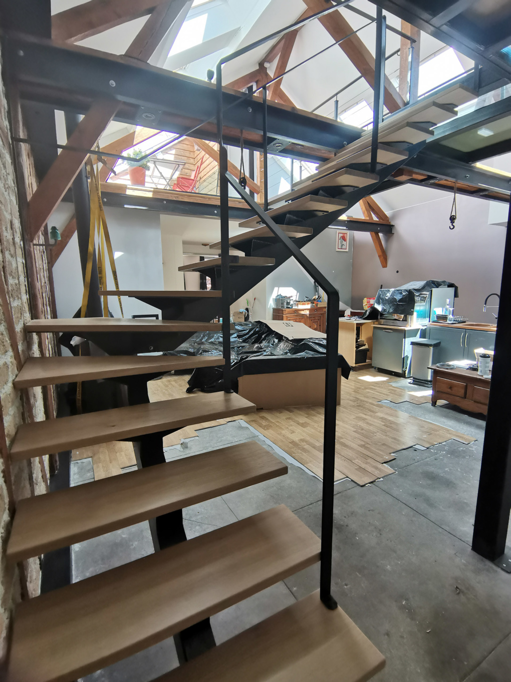 Escalier sur mesure en acier patiné et chêne massif intégré dans un loft contemporain